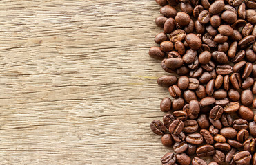 Coffee beans on old wood background