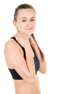 young woman sport trainer with slim body in sport clothes hands on neck in white background