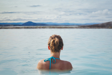 woman relaxing in hot tube blue lagoon in Iceland, happy tourist in spa, tourism