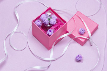 Open gift box with perfume. Fragrance as present for woman concept