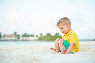 Fototapeta na wymiar Three year old toddler boy on beach. Summer family vacation at Maldives.