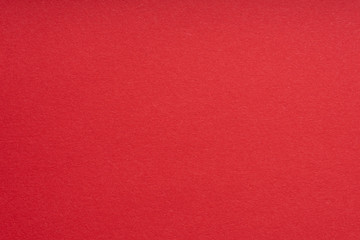 Paper background red color. Rough paper texture. Closeup. Macro.