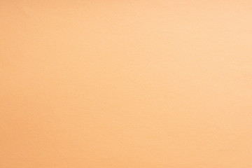 Fototapeta premium Paper background coral color. Rough paper texture. Closeup. Macro.