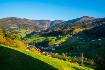 Germany, Romantic evening sunlight in valley of high black forest village in springtime