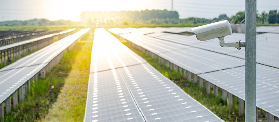 CCTV camera monitoring solar panels or polycrystalline silicon solar cells in the farm. Security in solar power plant. Photovoltaic modules for renewable energy © zephyr_p