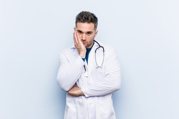 Young handsome doctor man who is bored, fatigued and need a relax day.