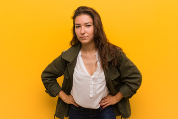 Young european woman isolated over yellow background scolding someone very angry.