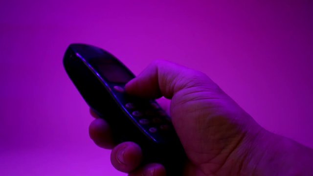 Close-Up Of Old Black Button Mobile Phone. Man&rsquo;s Fingers Dialing Random Numbers.