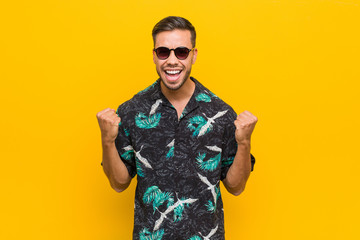Obraz premium Young filipino man wearing summer clothes cheering carefree and excited. Victory concept.