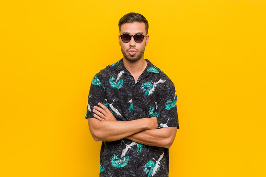 Young wearing summer clothes blows cheeks, has expression. Facial expression concept. | Adobe Stock