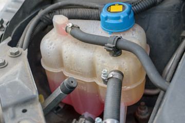 Radiator reservoir with water coolant (antifreeze) below minimum level