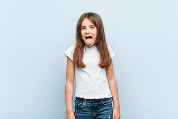 Obraz premium Cute girl funny and friendly sticking out him tongue.