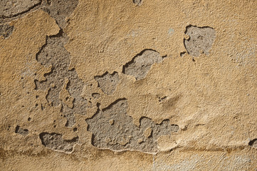 Close-up of plaster peeling off an old wall forming a quaint background at Caceres