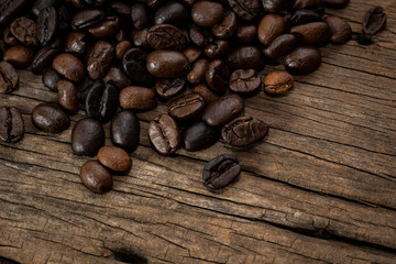 Coffee beans on old wood background