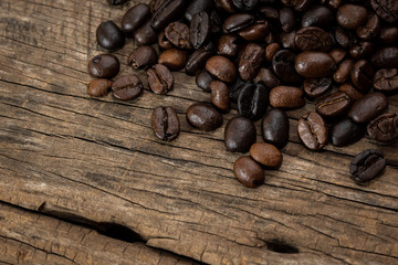 Roasted coffee beans on old wooden floors