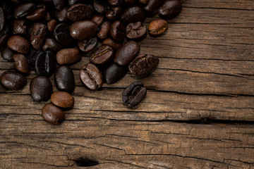 Coffee beans on old wood background