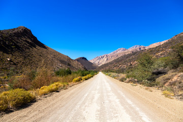 Gravel road between mountains
