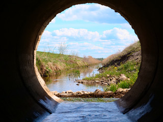 Dirty sewage along with sewage in an open ditch along the street. Dirty drainage, an open sewer collector here with toxic algae. E. Cological problem. Concept of: Slow Motion, Spring, Inside.
