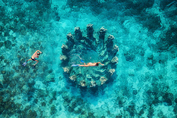 The couple snorkeling near the famous place on Gili Meno Island, Indonesia. Aerial view from drone. Underwater tourism in the ocean. Vacation and adventure. Travel - image