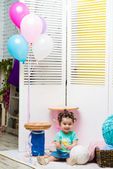 Obraz na płótnie Canvas Happy smiling sweet baby girl sitting with birthday balloons, Birthday girl, One years old