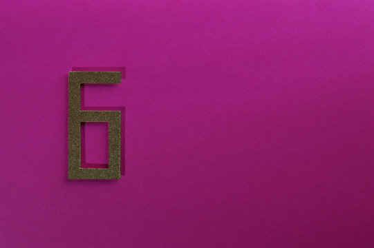 gold number six on pink background
