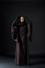Naklejka na ściany i meble full length view of woman in death costume on black