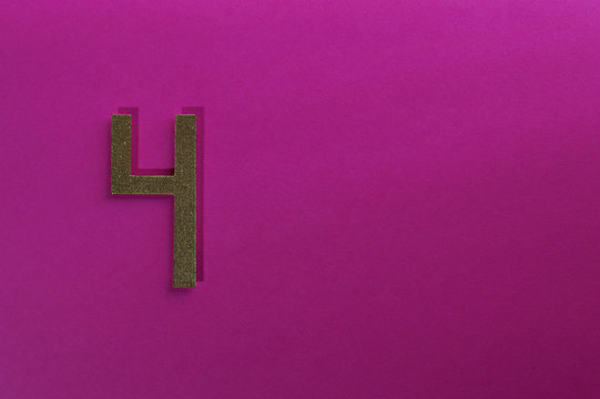 gold number four on pink background