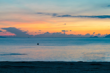 Amazing colorful sky at dawn over ocean on beach