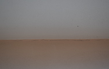  White wall on brown floor to use as a background