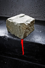 Blank paved stone on stairs with blood drop