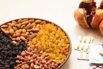 Pills and capsules in white background with fresh fruits. Multivitamins and supplement from fruits concept. Nuts mixed and fresh fruit to raise immunity 