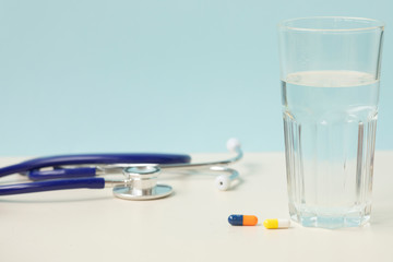 Stethoscope and medicine on a light background 