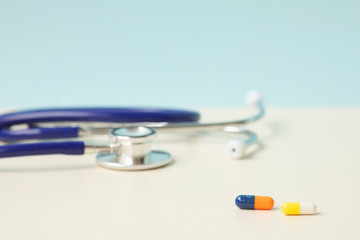 Stethoscope and medicine on a light background 