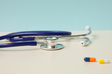 Stethoscope and medicine on a light background 