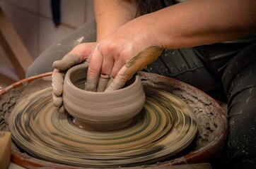 Women's hands at work on a potter's wheel