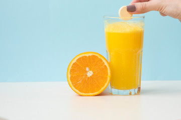 Effervescent vitamin C tablet bubbles in glass of water