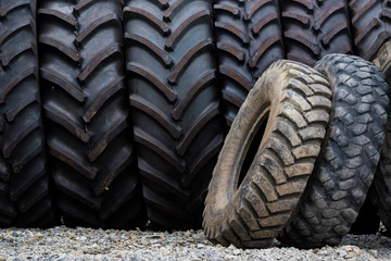 Close up several used black truck tires