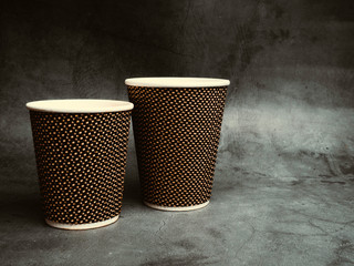 takeaway Paper cups of coffee on table, isolated on concrete background