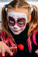 Child looking at camera , dressed in costume for Halloween party.
