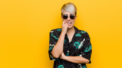 Young curvy woman wearing a summer look biting fingernails, nervous and very anxious.