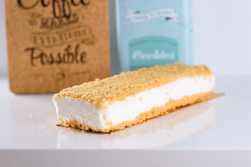 Fluffy, creamy New York Style Cheesecake topped with Crumb on white wood table.Cheesecake is super popular in Israel, in Shavuot-that happy, bright and colorful holiday and year-round. 