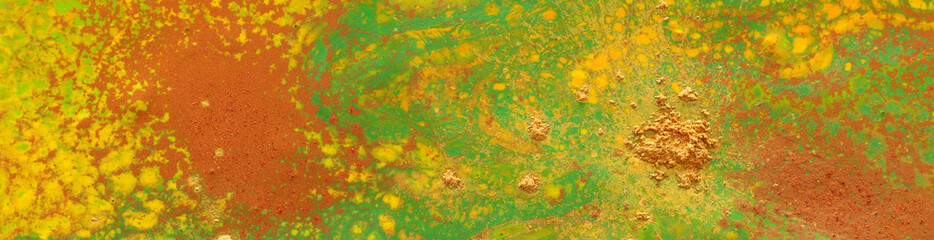 photography of abstract marbleized effect background. green and orange creative colors. banner