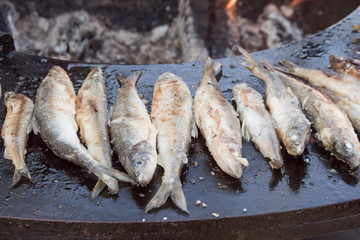 Fried fish lamb on the brazier. Street food.