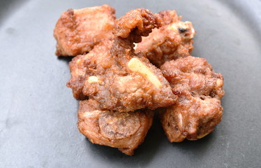 fried fermenting pork bone with garlic on plate
