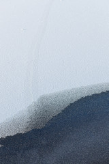 Snow on frozen lake ice surface