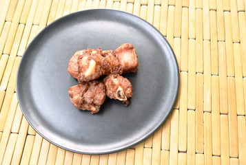 fried fermenting pork bone with garlic on plate
