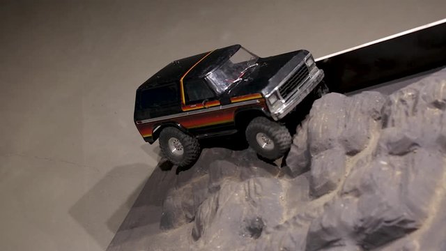 The car is running over an offroad terrain track. Free time. Children and adults concept. Hobby. Toys. 