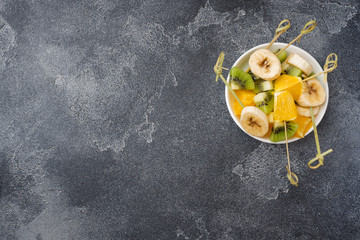 Fresh fruit on skewers for fondue. Table for summer party Copy space