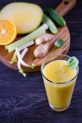 Mango Orange Ginger Cucumber and Celery Smoothie. Fruit and Vegetable Smoothie - healthy diet and detox drink. vertical