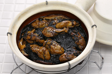 braised dried oysters with black moss (ho see fat choy ) in pot, traditional chinese new year dish